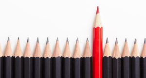 red pencil among black pencils